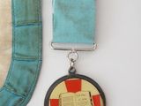 a medal with a cross on it next to a ribbon
