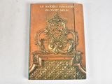 a book with a golden cover sitting on a table