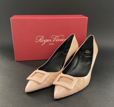 a pair of nude colored shoes with a box in the background