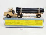 a toy truck with a large pipe on the back of it