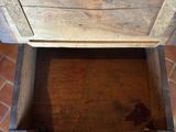 a person standing next to a wooden box on the floor