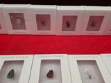 six boxes of different types of stones on display in a store