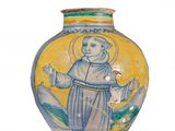 un vase jaune sur lequel est représenté un moine