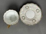 an image of a cup and saucer sitting on top of a table