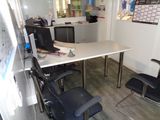 a desk with a chair and a computer on it