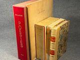 three books are stacked on top of each other on a gray surface