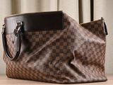 a brown and black handbag sitting on a table