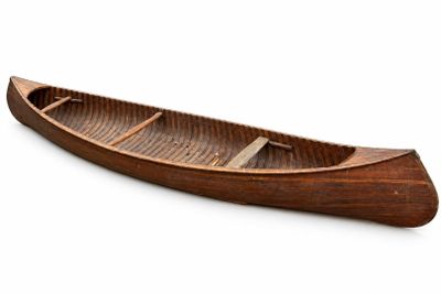 a wooden boat that is sitting on a white surface