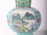 a blue vase with a painting on it sitting on a table
