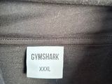 a close up of a label on a shirt that says gym shark xxxl