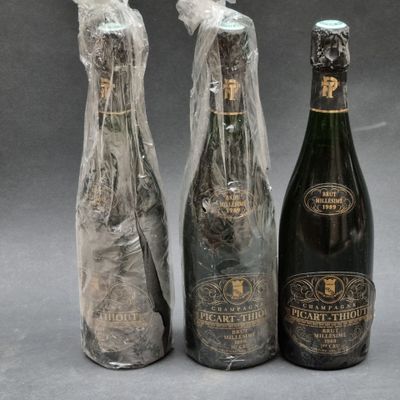 three bottles of wine wrapped in plastic and wrapped in plastic wrap