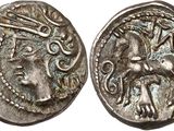 a silver coin with an image of a woman and a man on it