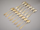 six silver spoons and two silver spoons on a table