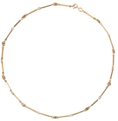 a gold chain necklace with small beads on a white background