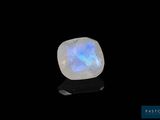 a white oplite stone on a black surface