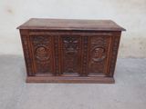an old wooden chest sitting on top of a cement floor