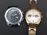 an image of a couple of watches sitting next to each other on a table
