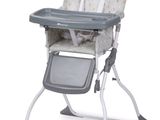 a baby high chair that has a tray in it