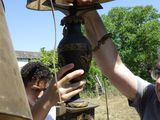 a man that is putting a lamp on top of a table