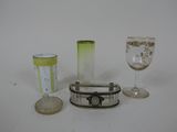 three wine glasses and a glass holder on the table