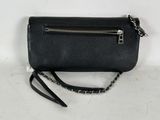 the small black purse is sitting on a white surface