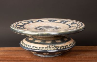 un bol noir et blanc posé sur une table en bois