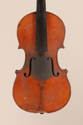 un vieux violon posé sur une surface blanche