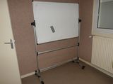 a white board on a stand in a room