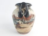 a vase that has a handle on it
