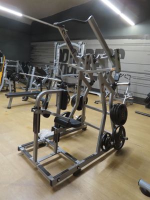 a gym with a lot of machines in the room