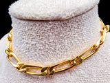 gold plated necklace with a thick link on a mannequin mannequin mannequin mannequin mannequin mannequin mannequin mann