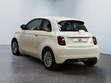 a small white car that is parked in a room