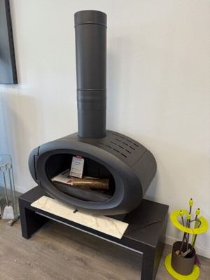 a black stove sitting in the corner of a living room