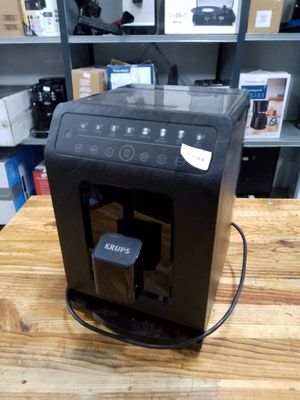 a coffee machine sitting on a wooden table in a store