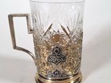 a glass cup with a handle on a white surface