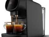 a close up of a coffee machine with two cups of coffee