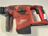 a close up of a drill on a table with a white background