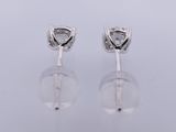 a pair of diamond earrings on a white background