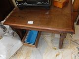 a small table with a suitcase on top of it