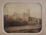 a picture of a picture of a castle on the side of a river