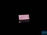 an image of a piece of pink quartz on a black background