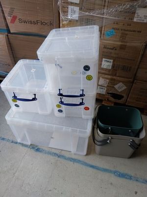 many plastic containers stacked on top of each other on the floor