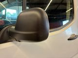 a side view mirror of a white truck in a garage