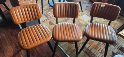 four chairs that are sitting in a room