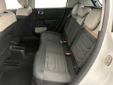 the back seats of a white car with black trims and a black seat belt