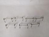 five pairs of hooks on a white surface