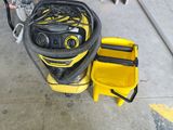 a yellow bucket with a hose and a yellow box with a yellow tool