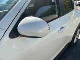 a white car that is parked on the side of the road
