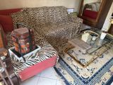 a leopard print couch and a coffee table in a living room