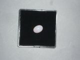 a white oplite in a black box on a white surface